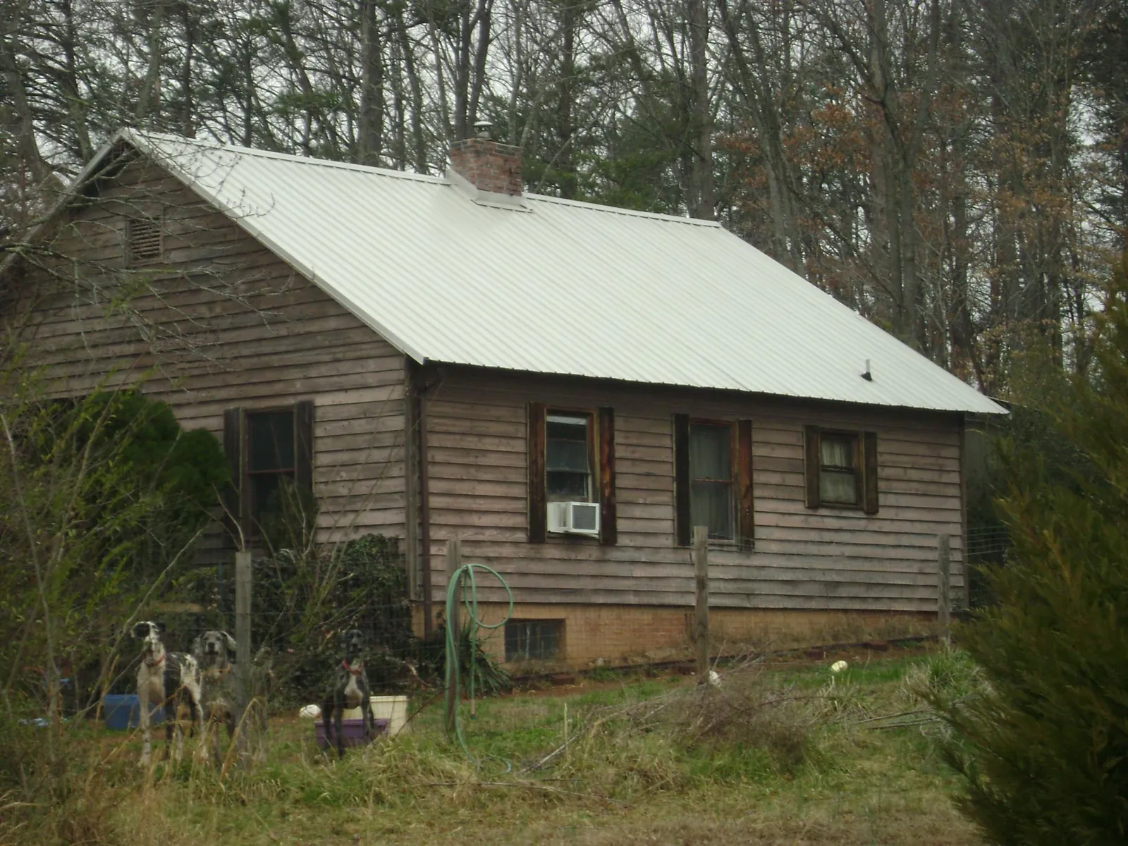 White metal roof on an old wood sided farmhouse, from a Metal Roof Installation job in Franconia